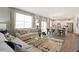 Open concept living and dining area with hardwood floors and neutral decor at 9876 Ceylon Ct, Commerce City, CO 80022