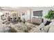 Open living room showcasing stylish furniture and a large TV at 9876 Ceylon Ct, Commerce City, CO 80022