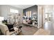 Home office with built-in shelving, desk, and comfortable seating at 9876 Ceylon Ct, Commerce City, CO 80022