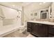 Bathroom featuring a modern shower, floating vanity, and ample counter space at 9734 Bennett Peak St, Littleton, CO 80125