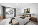 Bright bedroom featuring white walls, large window, stylish furnishings, and neutral decor at 1182 Sugarloaf Ln, Erie, CO 80516