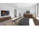 Comfortable bedroom with TV, traditional furnishings, neutral walls, and a view to the ensuite bath at 1182 Sugarloaf Ln, Erie, CO 80516