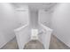 Staircase with carpeted steps leads to a landing with multiple doors at 1182 Sugarloaf Ln, Erie, CO 80516