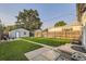 Lush backyard with a manicured lawn, wooden fence, and a storage shed at 2831 W Irvington Pl, Denver, CO 80219