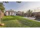 A charming backyard featuring a well-maintained lawn, wooden fence, and cozy patio with outdoor seating around a fire pit at 2831 W Irvington Pl, Denver, CO 80219