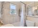 Bright bathroom features a tub, shower, decorative tile accents, and medicine cabinet at 2831 W Irvington Pl, Denver, CO 80219
