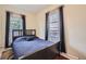 Comfortable bedroom featuring neutral walls, ample natural light, and contemporary window coverings at 2831 W Irvington Pl, Denver, CO 80219