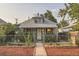 Charming home featuring a well-maintained front yard, gray shingle roof, and chain-link fence at 2831 W Irvington Pl, Denver, CO 80219