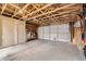 Spacious unfinished garage with concrete floor and exposed beams. Perfect for customization at 2831 W Irvington Pl, Denver, CO 80219