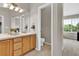 Bathroom showcasing a double sink vanity, toilet room, and window at 4678 Springmeadow Ln, Castle Rock, CO 80109