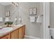 Well-lit bathroom featuring double sinks, a large mirror, and neutral tones at 4678 Springmeadow Ln, Castle Rock, CO 80109