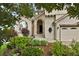 Charming home entrance with a stone-accented archway and landscaped garden at 4678 Springmeadow Ln, Castle Rock, CO 80109