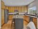 Well-lit kitchen with stainless steel appliances, an island, and granite countertops at 4678 Springmeadow Ln, Castle Rock, CO 80109