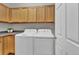 Functional laundry area with white washer and dryer, ample cabinet space, and a countertop at 4678 Springmeadow Ln, Castle Rock, CO 80109
