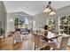 Open-concept living and dining area with vaulted ceiling and large windows at 4678 Springmeadow Ln, Castle Rock, CO 80109