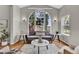 Bright living room featuring a large arched window and hardwood floors at 4678 Springmeadow Ln, Castle Rock, CO 80109