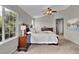 Spacious main bedroom with neutral walls, large window, and a ceiling fan at 4678 Springmeadow Ln, Castle Rock, CO 80109
