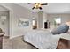Light-filled main bedroom with a tray ceiling, ceiling fan, and ensuite bathroom entrance at 4678 Springmeadow Ln, Castle Rock, CO 80109