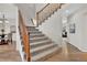 Carpeted staircase with wooden railings, leading to the upper level of the home at 4678 Springmeadow Ln, Castle Rock, CO 80109