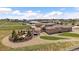 Aerial view of home showing backyard with pergola, hot tub, and landscaping, fenced in lot, and green space at 12590 Valentia St, Thornton, CO 80602