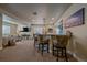 Basement wet bar features barstool seating, granite countertops, and stainless steel beverage cooler at 12590 Valentia St, Thornton, CO 80602