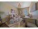 Comfortable home office with stylish decor, a daybed, a desk, and a large window at 12590 Valentia St, Thornton, CO 80602