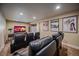 Basement home theater boasts tiered seating with leather recliners, and movie-themed posters at 12590 Valentia St, Thornton, CO 80602