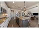 Bright kitchen featuring granite countertops, a large island, and stainless steel appliances at 12590 Valentia St, Thornton, CO 80602