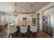Modern kitchen featuring an island with seating, pendant lighting, stainless steel appliances, and lots of counter space at 12590 Valentia St, Thornton, CO 80602