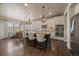 Bright kitchen featuring a large island with pendant lighting, stainless steel appliances, and a breakfast nook at 12590 Valentia St, Thornton, CO 80602