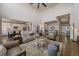 Open-concept living area with high ceilings, hardwood floors, and stylish furniture, seamlessly connecting the spaces at 12590 Valentia St, Thornton, CO 80602
