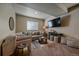 Basement living room featuring a sectional couch, entertainment center, neutral decor, and a plush rug at 12590 Valentia St, Thornton, CO 80602