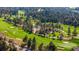 An aerial view of a lush golf course surrounded by mature trees at 60 Glenalla Pl, Castle Rock, CO 80108