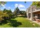 Expansive backyard featuring a well-maintained lawn, covered patio, and beautiful landscaping at 60 Glenalla Pl, Castle Rock, CO 80108