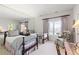 Comfortable bedroom with twin beds, a large mirror wall, light carpeting and large window with a view at 60 Glenalla Pl, Castle Rock, CO 80108