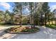 Circular driveway with mature trees and lush landscaping adds to the curb appeal of this home at 60 Glenalla Pl, Castle Rock, CO 80108