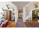 Grand hallway with hardwood floors, decorative rugs, and staircase access at 60 Glenalla Pl, Castle Rock, CO 80108