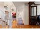 Hallway with hardwood floors and access to rooms throughout the home at 60 Glenalla Pl, Castle Rock, CO 80108