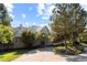 Beautiful home exterior featuring mature trees, lush landscaping, and an inviting driveway at 60 Glenalla Pl, Castle Rock, CO 80108