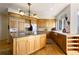 Bright kitchen boasts custom cabinets, granite countertops, island, and stainless steel appliances at 60 Glenalla Pl, Castle Rock, CO 80108
