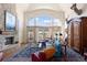 Bright living room featuring a large window, fireplace, and comfortable seating area at 60 Glenalla Pl, Castle Rock, CO 80108