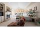 Bright main bedroom with fireplace, sitting area, and large windows offering ample natural light and outside views at 60 Glenalla Pl, Castle Rock, CO 80108