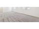 Spacious finished basement with plush carpeting and natural light from windows at 9265 Cathay Ct, Commerce City, CO 80022