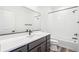 Bathroom with a white countertop, black fixtures, and a combined shower and tub at 9265 Cathay Ct, Commerce City, CO 80022