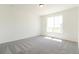 Bright bedroom with neutral carpet, ample natural light from a large window at 9265 Cathay Ct, Commerce City, CO 80022
