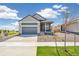 Charming single-Gathering home showcasing a two-car garage and xeriscaped front yard at 9265 Cathay Ct, Commerce City, CO 80022