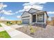 Charming single-Gathering home showcasing a two-car garage and xeriscaped front yard at 9265 Cathay Ct, Commerce City, CO 80022