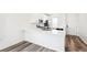 Bright kitchen with white cabinets, bar seating and stainless steel appliances at 9265 Cathay Ct, Commerce City, CO 80022