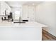 Bright kitchen with white cabinets, bar seating and stainless steel appliances at 9265 Cathay Ct, Commerce City, CO 80022