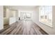 Open concept living space featuring light gray wood floors and ample natural light at 9265 Cathay Ct, Commerce City, CO 80022